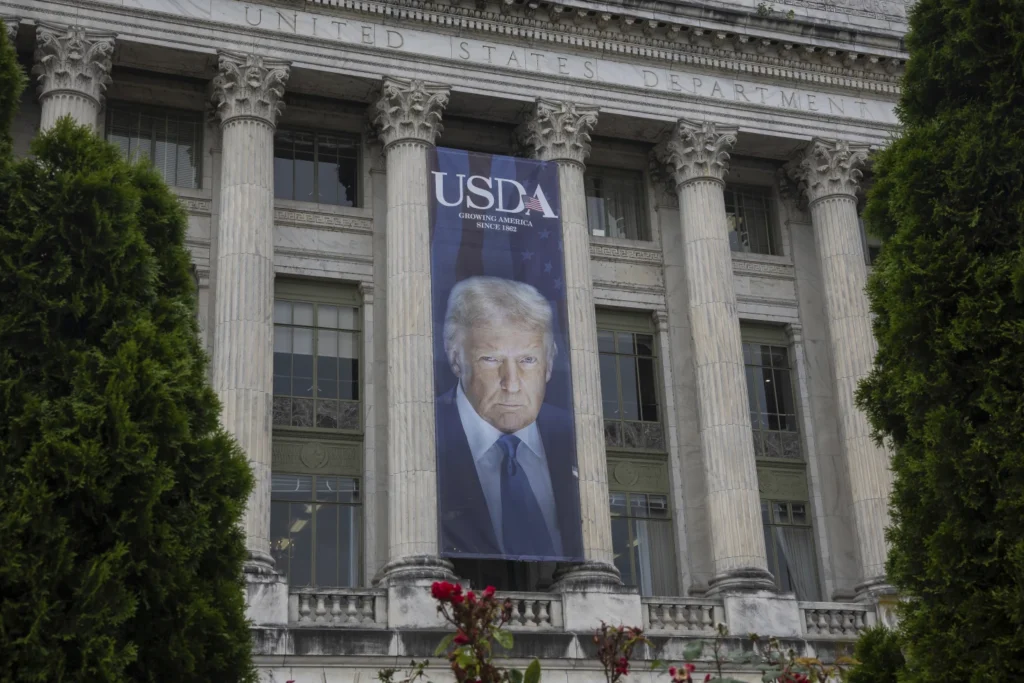 A banner with President Trump's face reading USDA: growing America since 1852