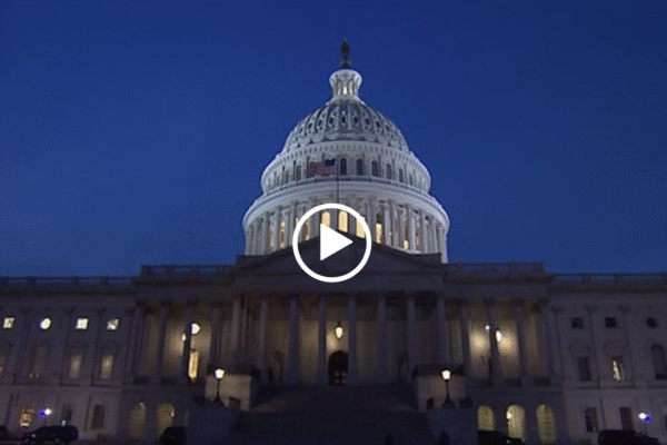 The U.S. Capitol with a play button overlaid