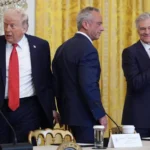 President Donald Trump arrives to an event to promote investment in rural health care in the East Room of the White House, Friday, Jan. 16, 2026, in Washington. Standing with the President are Secretary of Health and Human Services, Robert F. Kennedy, Jr., and Mehmet Oz, Administrator for the Centers for Medicare & Medicaid Services. (AP Photo/Evan Vucci)