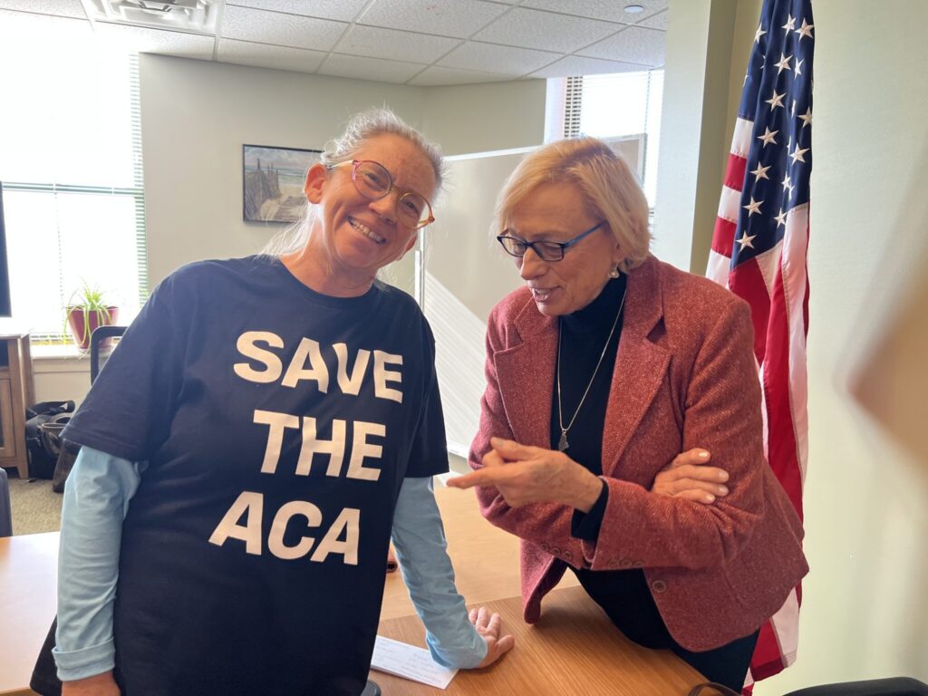 Kennebunk resident Rachel Phipps, here pictured with Gov. Janet Mills, is forgoing health insurance due to spiking costs. (Photo by Eesha Pendharkar/ Maine Morning Star)