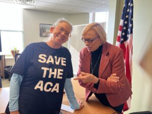 Kennebunk resident Rachel Phipps, here pictured with Gov. Janet Mills, is forgoing health insurance due to spiking costs. (Photo by Eesha Pendharkar/ Maine Morning Star)