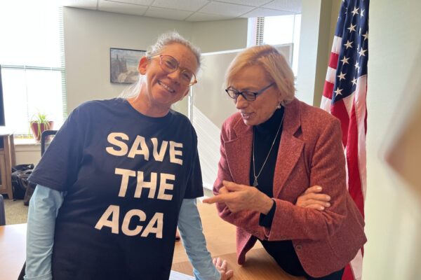 Kennebunk resident Rachel Phipps, here pictured with Gov. Janet Mills, is forgoing health insurance due to spiking costs. (Photo by Eesha Pendharkar/ Maine Morning Star)