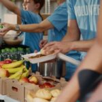 Photo credit: DC Studio/Shutterstock Volunteers placing fruit in boxes.