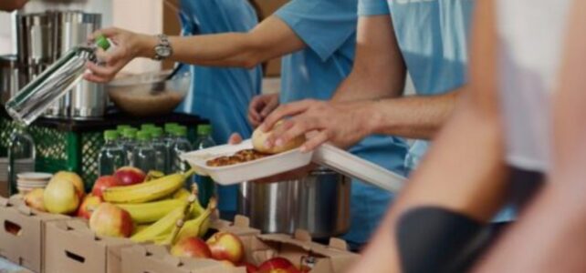 Photo credit: DC Studio/Shutterstock Volunteers placing fruit in boxes.