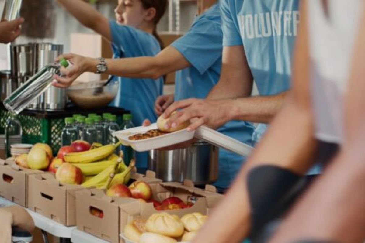 Photo credit: DC Studio/Shutterstock Volunteers placing fruit in boxes.