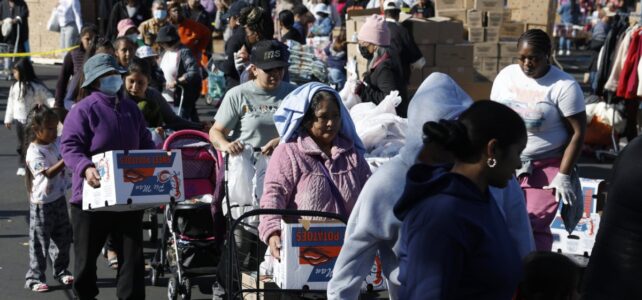 People in need line up to receive free food during a 2025 Thanksgiving food giveaway in Oakland, California. Tens of thousands of Bay Area households turned to emergency groceries after a temporary halt in SNAP benefits worsened already high levels of food insecurity. (Photo credit: Justin Sullivan/Getty Images)